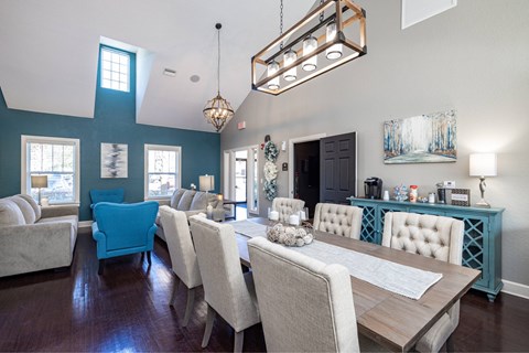 A dining room with a long table and chairs.