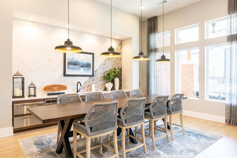 A modern dining room with a large table and chairs.