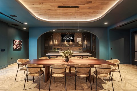 A dining room with a wooden table and chairs.