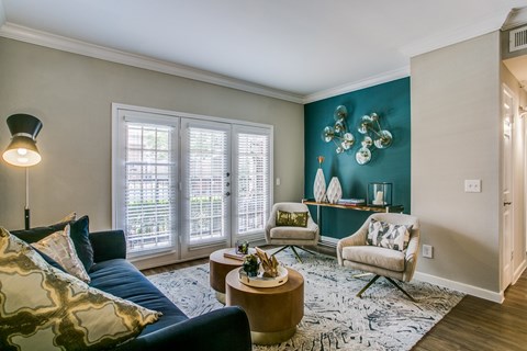 A living room with a blue couch and a coffee table.
