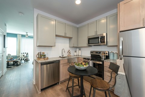 A modern kitchen with a table and chairs.