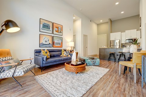 A living room with a blue couch and a coffee table.