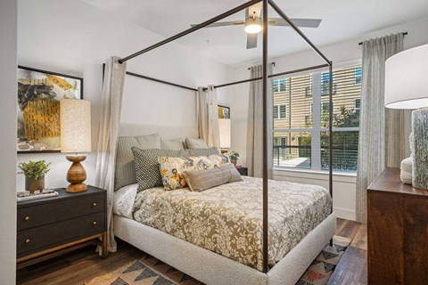 a bedroom with a canopy bed and a window