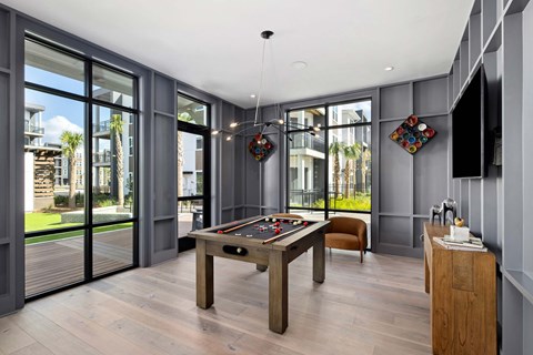 A room with a pool table and a chair.