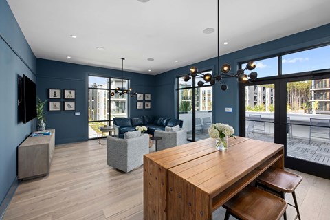 A modern living room with a wooden table and chairs.