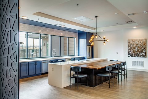 A modern kitchen with a wooden table and chairs.