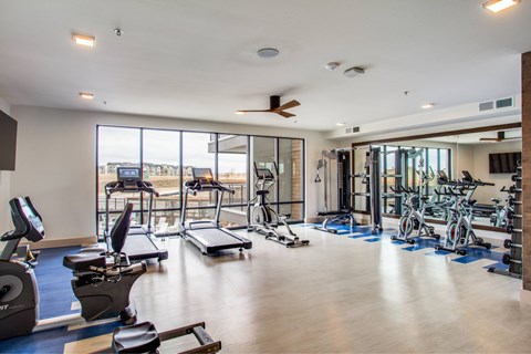 A spacious gym with treadmills at the Vista at Razyor Ranch in Denton Texas