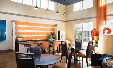 A modern dining room with a wooden table and chairs.
