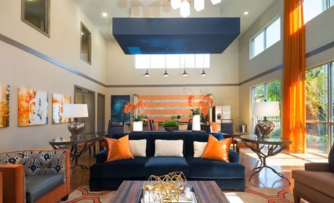 A living room with a blue couch and a coffee table.