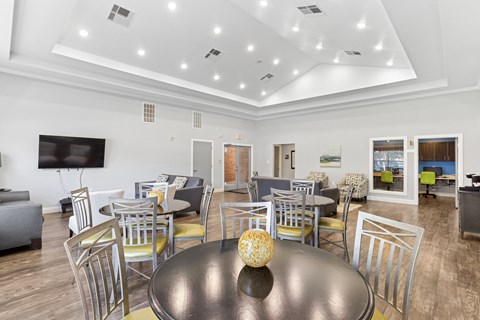 A modern dining room with a large table and chairs.