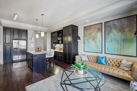 A modern kitchen with dark wood cabinets and a glass table.