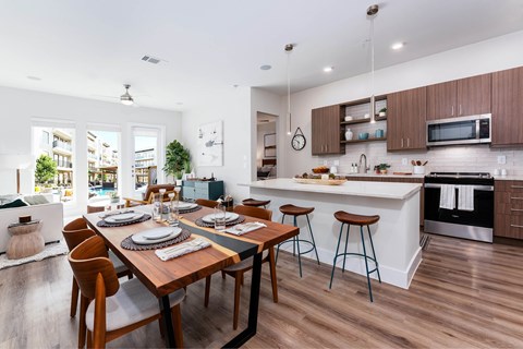 A modern kitchen with a dining table set for four.