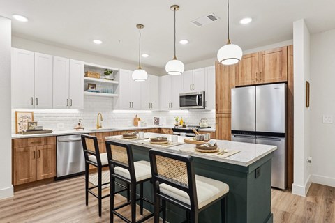 A kitchen with a dining table and chairs.