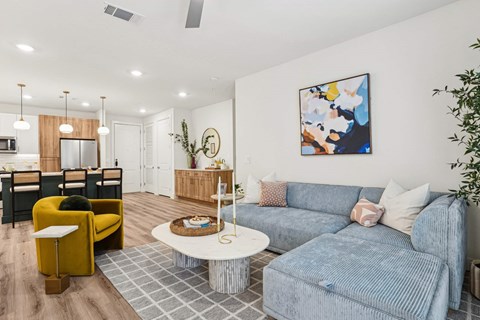 A living room with a grey couch and a yellow chair.