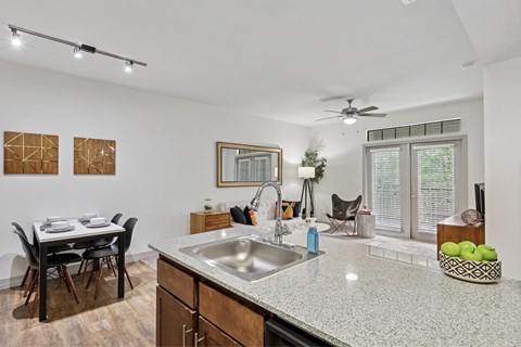 A kitchen with a dining table and chairs.