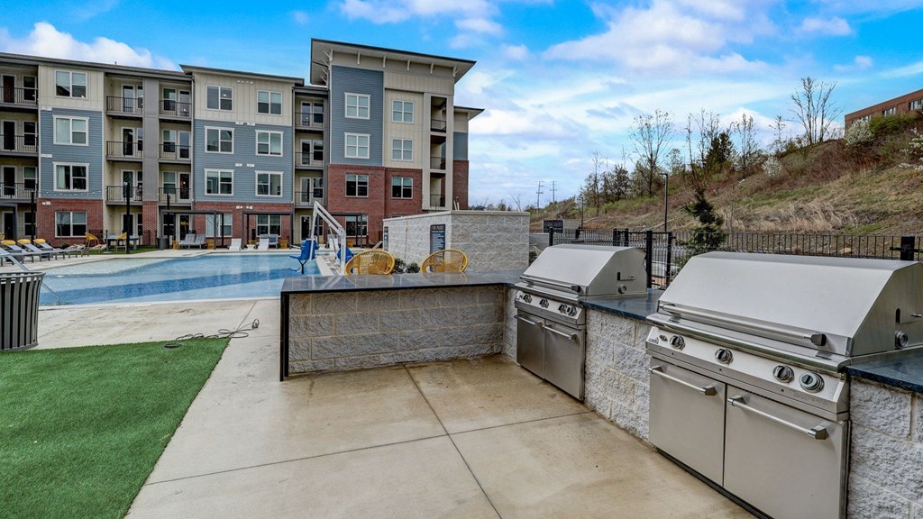 Apartment complex with a pool and outdoor grill area. Apartment complex with a pool and outdoor grill area.