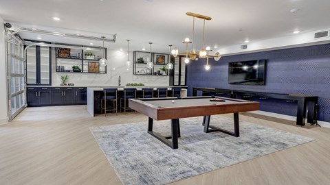 A modern living room with a wooden table and a television.