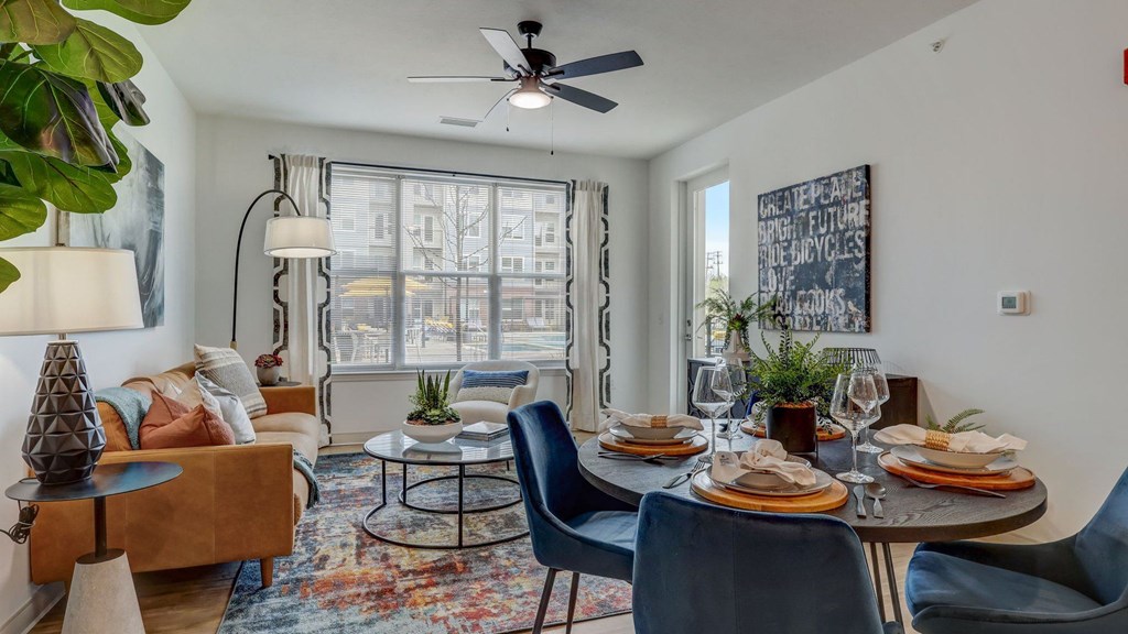 A dining room with a table set for six and a view of the city. A dining room with a table set for six and a view of the city.