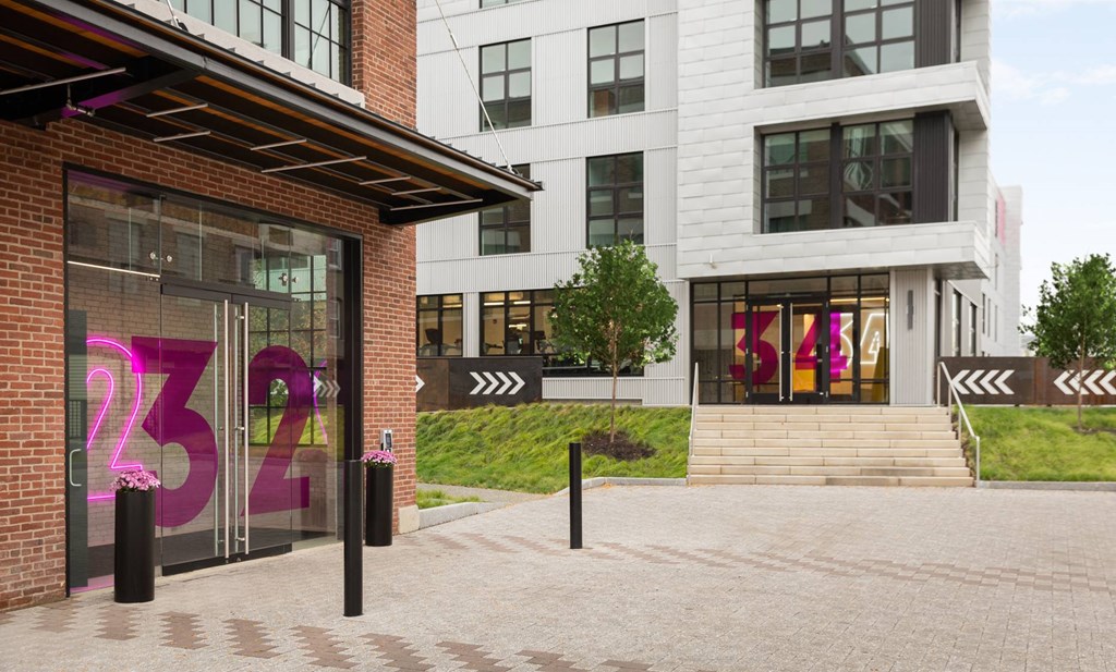 A building with a glass door that has the number 232 on it.