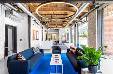 A modern living room with a blue couch and a coffee table.