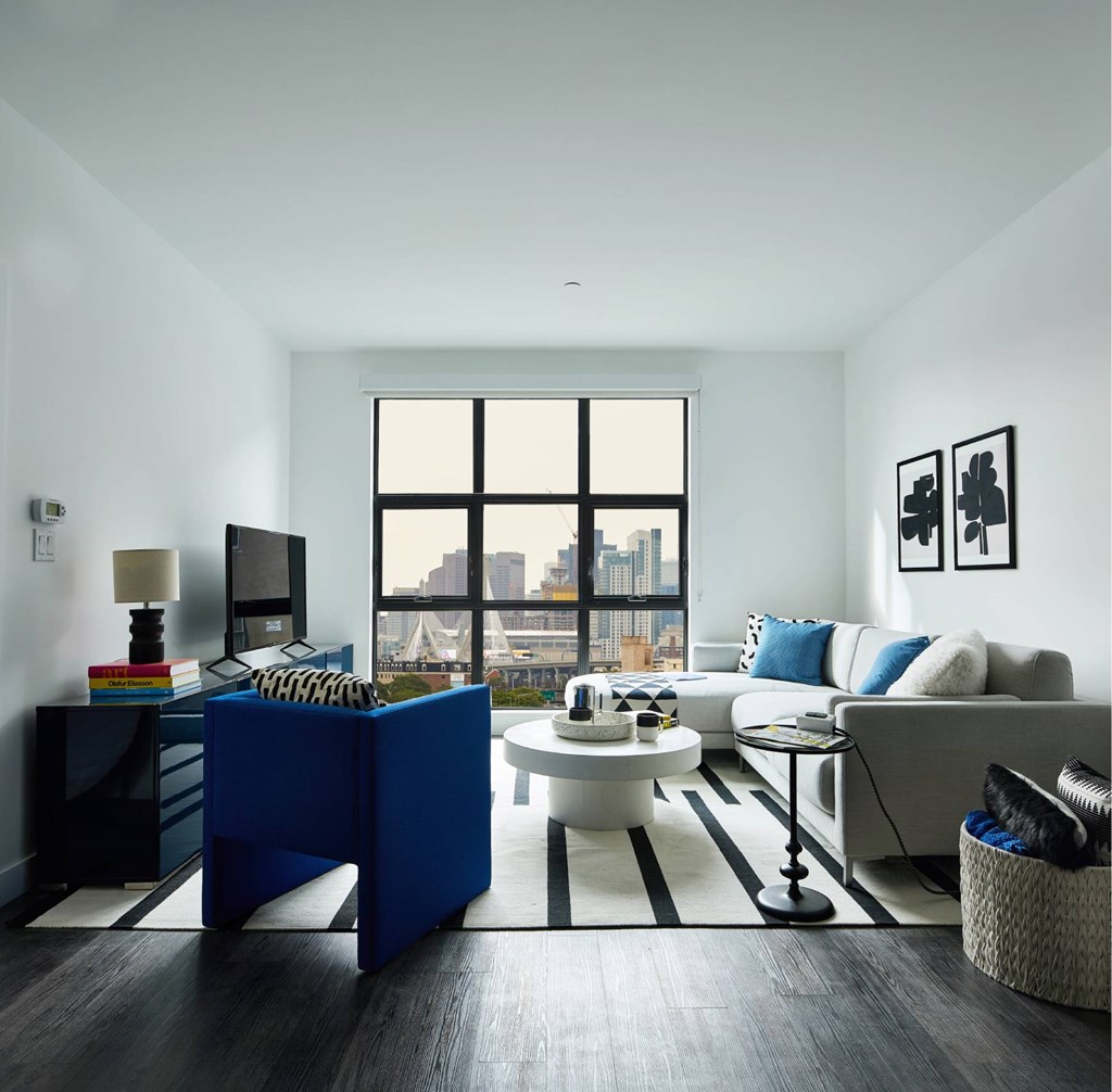 A living room with a blue sofa and a white coffee table.