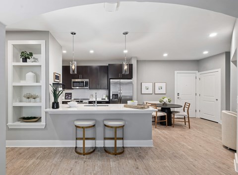 A modern kitchen with a bar area and a dining table set up.