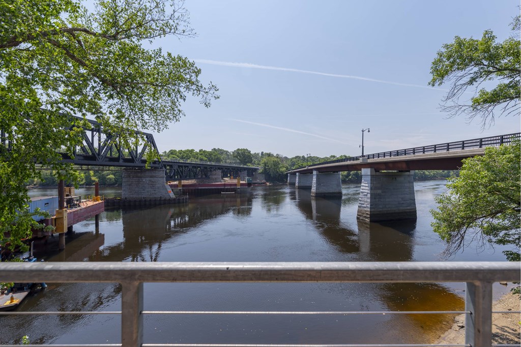A bridge over a river with a clear sky.