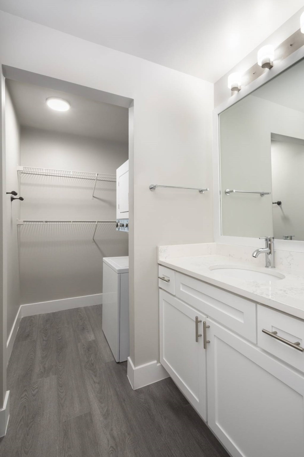 A bathroom with a white sink and a white cabinet.
