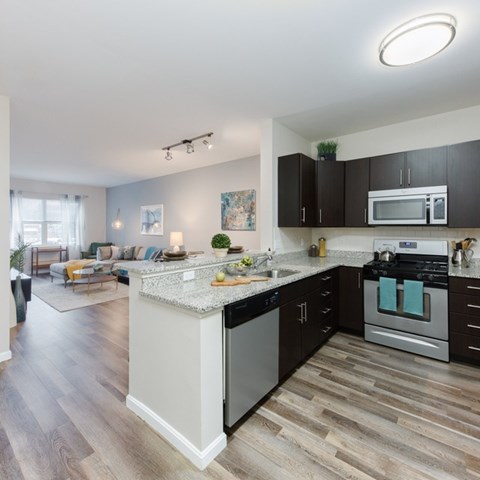 A modern kitchen with dark wood cabinets and a white island.