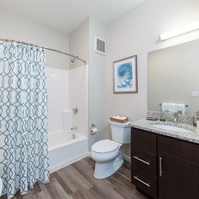A bathroom with a toilet, sink, and shower.