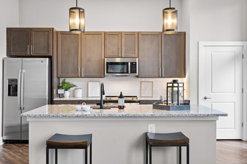 A kitchen with a white refrigerator and wooden cabinets.