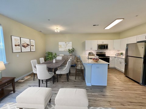 A kitchen with a dining table and chairs.