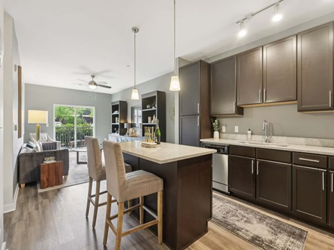 A kitchen with brown cabinets and a white island.