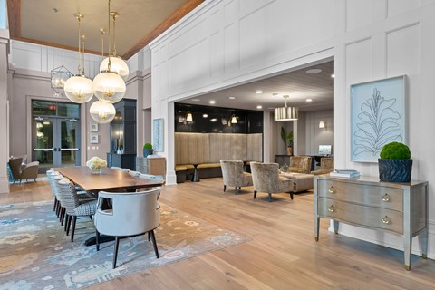 A modern dining room with a wooden table and chairs.