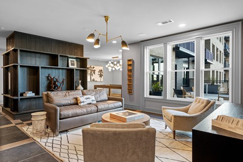 A living room with a brown couch and a wooden coffee table.