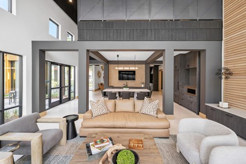A modern living room with a grey sofa and a wooden coffee table.