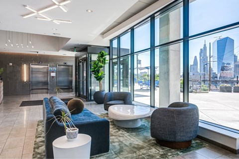 A modern lobby with a view of the city skyline.