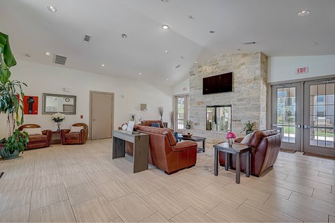 A spacious waiting room with a stone fireplace and comfortable seating.