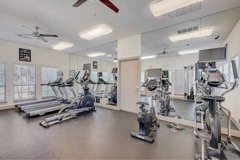 A spacious gym with a variety of exercise equipment.