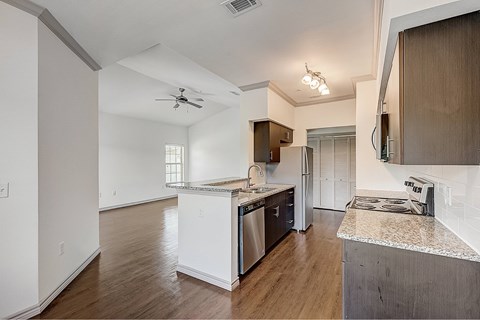 A kitchen with a refrigerator, stove, and oven.
