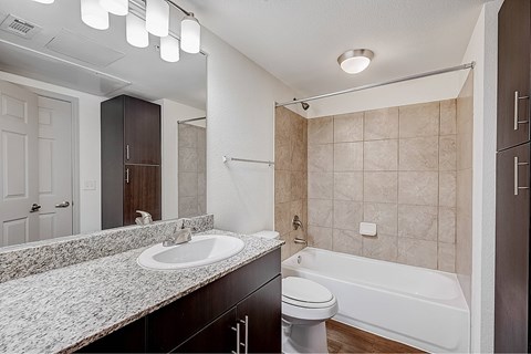 A bathroom with a sink, toilet, and bathtub.