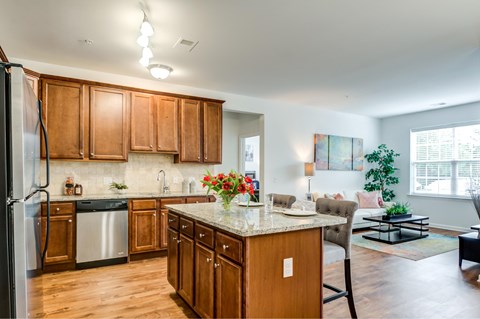 A kitchen with wooden cabinets and a refrigerator.