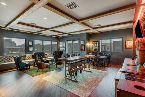 A modern room with a long table and chairs at The Academic in Dallas Texas