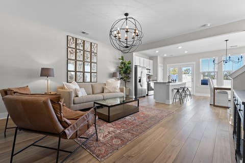 A modern living room with a brown leather chair and a glass coffee table.