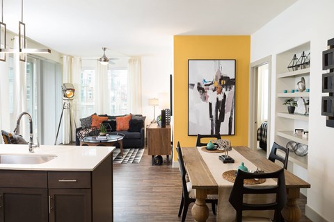 A modern kitchen with a wooden table and chairs.