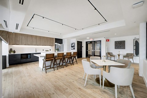 A modern kitchen with a dining table and chairs.