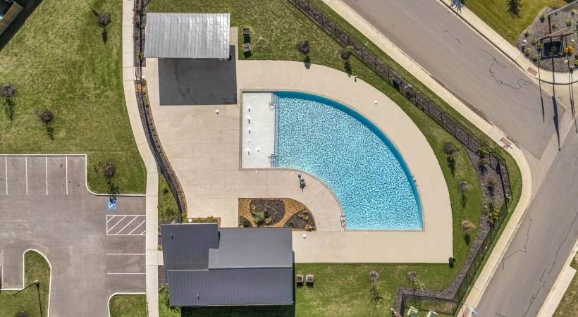 an aerial view of a swimming pool and a house