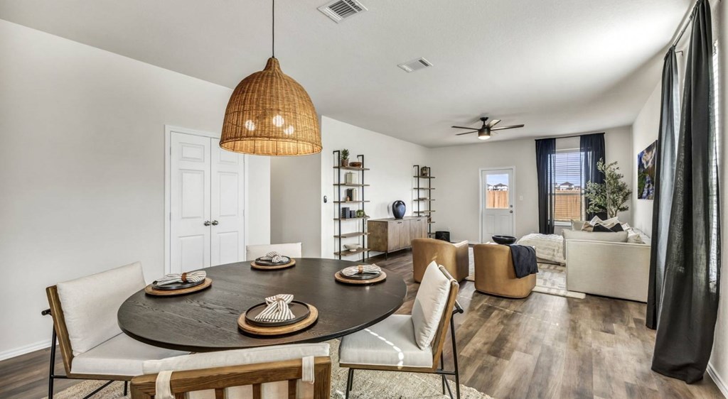 a dining room and living room with a table and chairs