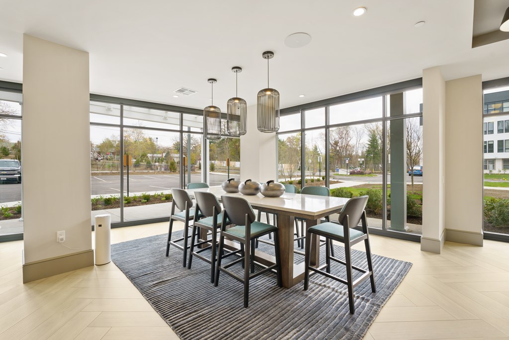 A dining room with a table and chairs.