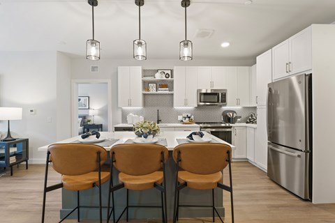 A modern kitchen with a dining table and chairs.